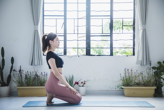 asian woman practicing yoga in a yoga studio