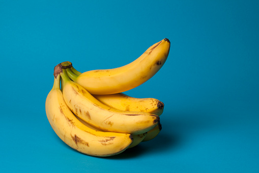 A bunch of bananas with one banana sticking up, suggestive of an erection