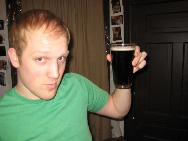 Kevin James Doyle, younger, holds a pint of Guinness