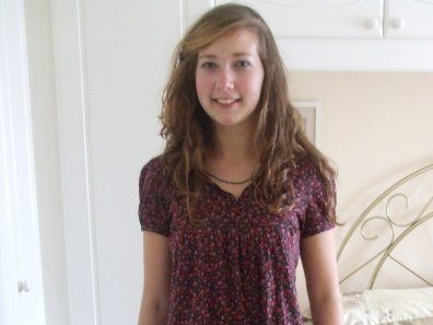Younger Alex Meyer smiles in a dark, roomy top